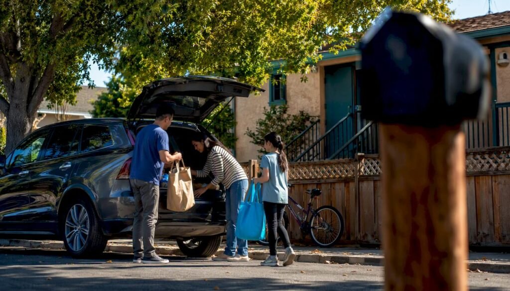 Family unloading groceries at Fremont home
